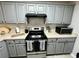 Nicely updated kitchen featuring gray cabinets, stainless steel appliances, and subway tile at 19 Pistachio Loop # G, Murrells Inlet, SC 29576