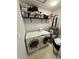Functional laundry area with appliances, shelving, and water heater at 19 Pistachio Loop # G, Murrells Inlet, SC 29576