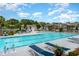 Large community pool with lounge chairs, umbrellas, and meticulously kept landscaping at 19 Pistachio Loop # G, Murrells Inlet, SC 29576