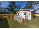 A home backyard with a wooden fence and white porch railing at 2939 King St., Loris, SC 29569