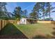 Beautiful home backyard with a wooden fence and white porch railing at 2939 King St., Loris, SC 29569