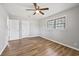 View of the bedroom, featuring a ceiling fan, a bright window, and neutral walls and flooring at 2939 King St., Loris, SC 29569