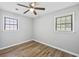 Cozy bedroom features modern ceiling fan, wood-look flooring, and gray walls at 2939 King St., Loris, SC 29569