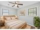Bedroom featuring a wood bed frame, ceiling fan, and two bright windows at 2939 King St., Loris, SC 29569