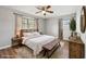 The bedroom features wood furniture, neutral walls and floor, an area rug and bright windows at 2939 King St., Loris, SC 29569