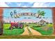 A historic community mural showing the town's past with a tractor and farmland, celebrates Loris, SC at 2939 King St., Loris, SC 29569