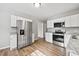 Bright kitchen featuring stainless steel appliances, granite countertops and modern wood flooring at 2939 King St., Loris, SC 29569