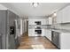 Well-lit kitchen boasts modern appliances, white cabinetry, stone countertops, and a spacious layout at 2939 King St., Loris, SC 29569