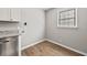 Laundry room features connections for washer and dryer, white cabinets, and grey countertop at 2939 King St., Loris, SC 29569