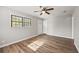 Hard surface floor living room features a white door, ceiling fan, window and light grey walls at 2939 King St., Loris, SC 29569
