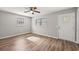 Bright living area with hard surface floors, light grey walls, two windows and a ceiling fan at 2939 King St., Loris, SC 29569