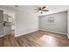 Open-concept living room with modern flooring, neutral walls, ceiling fan and view into kitchen at 2939 King St., Loris, SC 29569