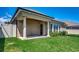 Beautiful backyard with lush green grass, mature landscaping, and a covered patio, perfect for outdoor relaxation at 311 Las Olas Dr., Myrtle Beach, SC 29577