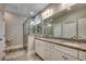 Bathroom with granite countertop double sinks and a walk-in shower with glass door at 311 Las Olas Dr., Myrtle Beach, SC 29577