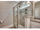 Bathroom featuring a glass walk-in shower with designer tilework and granite countertop sink at 311 Las Olas Dr., Myrtle Beach, SC 29577