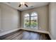Bedroom featuring hardwood flooring and a view of a street through two arched windows at 311 Las Olas Dr., Myrtle Beach, SC 29577