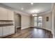 Bright dining area offers wood floors, plenty of natural light, white cabinets, and room to host a dinner at 311 Las Olas Dr., Myrtle Beach, SC 29577