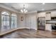 Dining room with stainless steel refrigerator and range, arched windows, and hardwood flooring at 311 Las Olas Dr., Myrtle Beach, SC 29577
