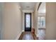 Inviting foyer with decorative front door, white trim, and wood flooring leading to the home's living spaces at 311 Las Olas Dr., Myrtle Beach, SC 29577