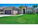 Charming brick home with a well-manicured lawn, beautiful landscaping, and an attached two-car garage at 311 Las Olas Dr., Myrtle Beach, SC 29577