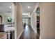 Open hallway showcases wood floors, neutral paint, and archways connecting the kitchen, living and Gathering rooms at 311 Las Olas Dr., Myrtle Beach, SC 29577