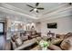 Comfortable living area with tray ceiling, fan, wood floors, open to the kitchen, and plenty of seating at 311 Las Olas Dr., Myrtle Beach, SC 29577