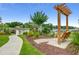 Tranquil outdoor scene featuring a wooden swing set amidst lush greenery and a serene waterfront view at 311 Las Olas Dr., Myrtle Beach, SC 29577