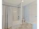 Bathroom with blue walls, tiled floors, and a shower-tub combination with a light blue curtain at 4017 Chalmers Ct., Myrtle Beach, SC 29579