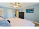 Bedroom with a ceiling fan, tv, neutral walls, and white trim at 4017 Chalmers Ct., Myrtle Beach, SC 29579