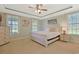 Relaxing bedroom with a tray ceiling, ceiling fan, and neutral tones at 4017 Chalmers Ct., Myrtle Beach, SC 29579