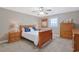 Bedroom with neutral colors, wood furnishings, plush carpeting, and a ceiling fan at 4017 Chalmers Ct., Myrtle Beach, SC 29579