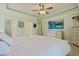 Bright bedroom featuring a ceiling fan, walk-in closet, and a large TV on the wall at 4017 Chalmers Ct., Myrtle Beach, SC 29579