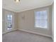 Neutral bedroom boasts a door to the outside, a window and tan carpet at 4017 Chalmers Ct., Myrtle Beach, SC 29579