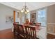 Traditional dining room featuring hardwood floors, tray ceiling, chandelier, and staircase at 4017 Chalmers Ct., Myrtle Beach, SC 29579