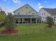 Aerial view of a beautifully landscaped backyard featuring a patio, screened porch, and well-manicured lawn at 4017 Chalmers Ct., Myrtle Beach, SC 29579