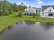Aerial view showcasing the property's backyard, pond, and lush landscaping, providing a serene setting at 4017 Chalmers Ct., Myrtle Beach, SC 29579