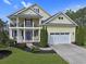 Charming two-story home featuring a porch, balcony, manicured lawn, and a two-car garage at 4017 Chalmers Ct., Myrtle Beach, SC 29579