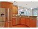 Modern kitchen with stainless steel appliances, wood cabinets, and a decorative backsplash at 4017 Chalmers Ct., Myrtle Beach, SC 29579