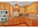 Updated kitchen featuring wood cabinets, granite counters, and modern appliances at 4017 Chalmers Ct., Myrtle Beach, SC 29579