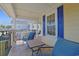 Covered porch with seating and blue accents create a relaxing outdoor space at 4017 Chalmers Ct., Myrtle Beach, SC 29579