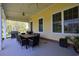Expansive outdoor dining area with a large table, grill, and ceiling fans for comfortable entertaining at 4017 Chalmers Ct., Myrtle Beach, SC 29579