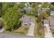 Aerial view of a single-Gathering home with a large yard and mature trees in a residential neighborhood at 7 Pine Valley Ln., Surfside Beach, SC 29575