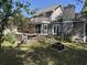 Spacious backyard featuring a deck with seating, a screened porch, and mature trees at 7 Pine Valley Ln., Surfside Beach, SC 29575