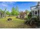 Lush backyard with a seating area, fire pit, and a well-maintained lawn, ideal for outdoor gatherings at 7 Pine Valley Ln., Surfside Beach, SC 29575