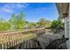 Wooden balcony with metal lounge chairs overlooking a fenced-in yard with greenery at 7 Pine Valley Ln., Surfside Beach, SC 29575