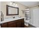 Bathroom with wood cabinets, a large mirror, a marble countertop, and a shower and tub at 7 Pine Valley Ln., Surfside Beach, SC 29575