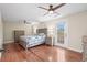 Spacious bedroom with a ceiling fan, wood floors, a balcony door, and wood furniture at 7 Pine Valley Ln., Surfside Beach, SC 29575