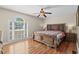 This primary bedroom has a hard wood floor, ceiling fan and large window at 7 Pine Valley Ln., Surfside Beach, SC 29575