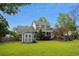 Exterior view of the house, featuring a spacious backyard, deck, shed and screened in porch at 7 Pine Valley Ln., Surfside Beach, SC 29575