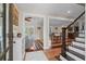 Elegant foyer showcasing hardwood floors, staircase, and seamless flow into the living and dining areas at 7 Pine Valley Ln., Surfside Beach, SC 29575